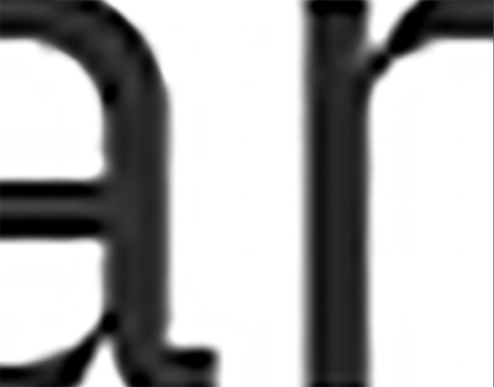 In place of the square on the left is a gif that moves quickly through different magnified black letterforms that at times appear architectural.